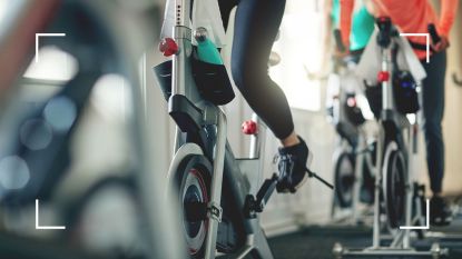 Woman with heels clipped into pedals, doing spinning for weight loss at the gym